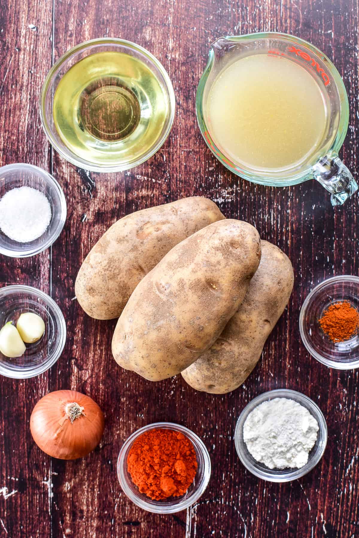 Patatas Bravas ingredients on a dark background