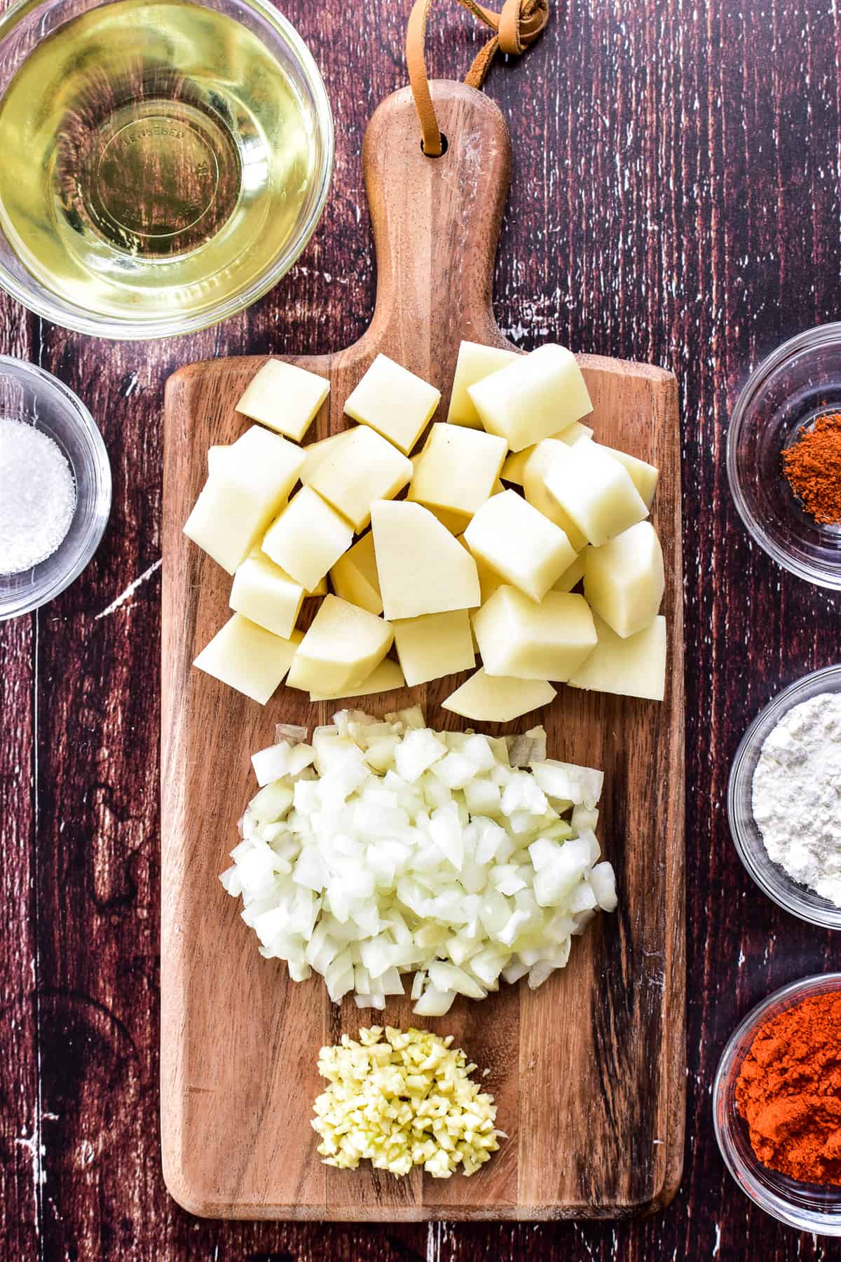 Potatoes, onions, and garlic prepped for Patatas Bravas