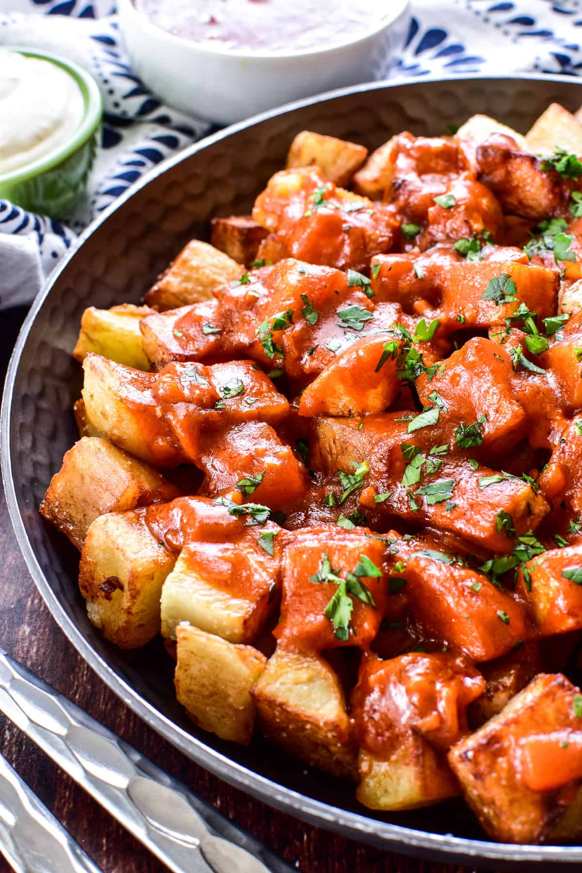 Close up of Patatas Bravas in a shallow bowl