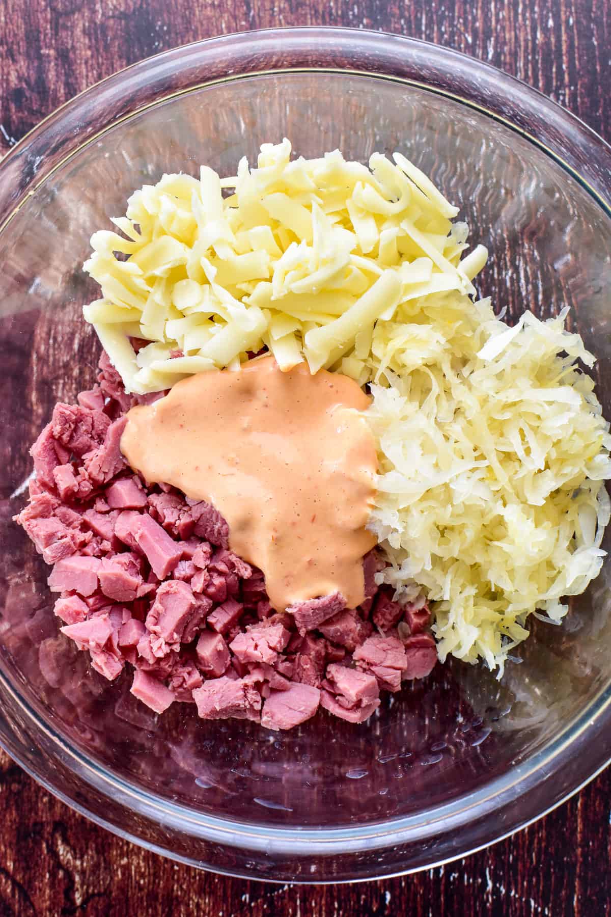 Ingredients for Reuben Wonton Cups in a mixing bowl