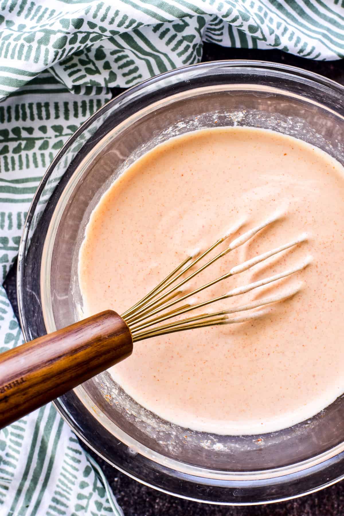 Overhead shot of Yum Yum Sauce in glass mixing bowl with whisk