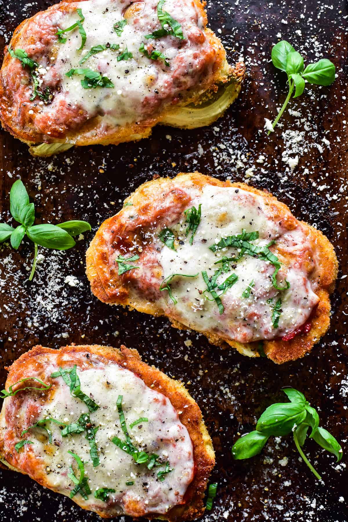 Overhead image of 3 Cauliflower Parmesan steaks