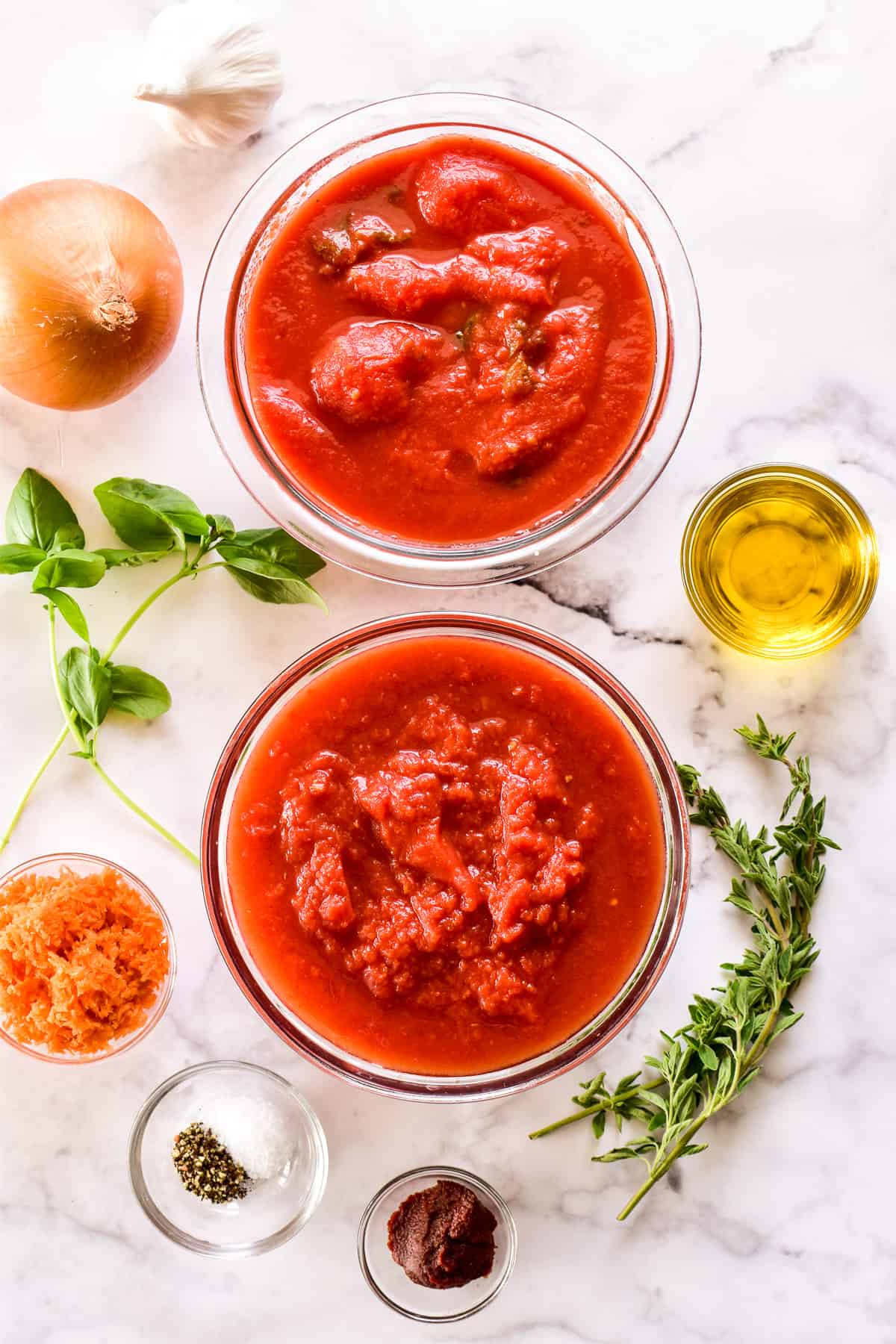 Marinara Sauce ingredients on a marble background