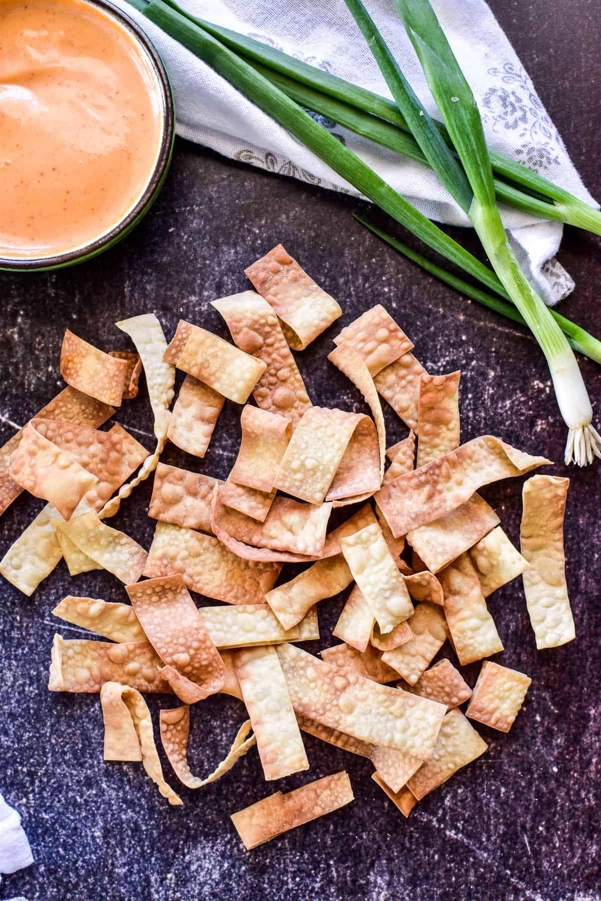 Overhead image of Crispy Wonton Strips with spicy mayo and green onions