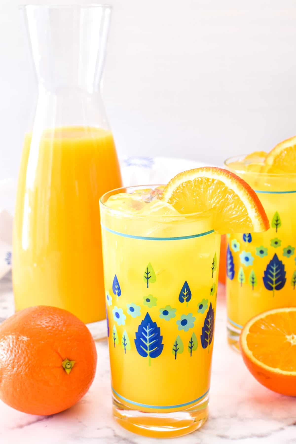 Screwdriver in a glass with orange juice in a carafe