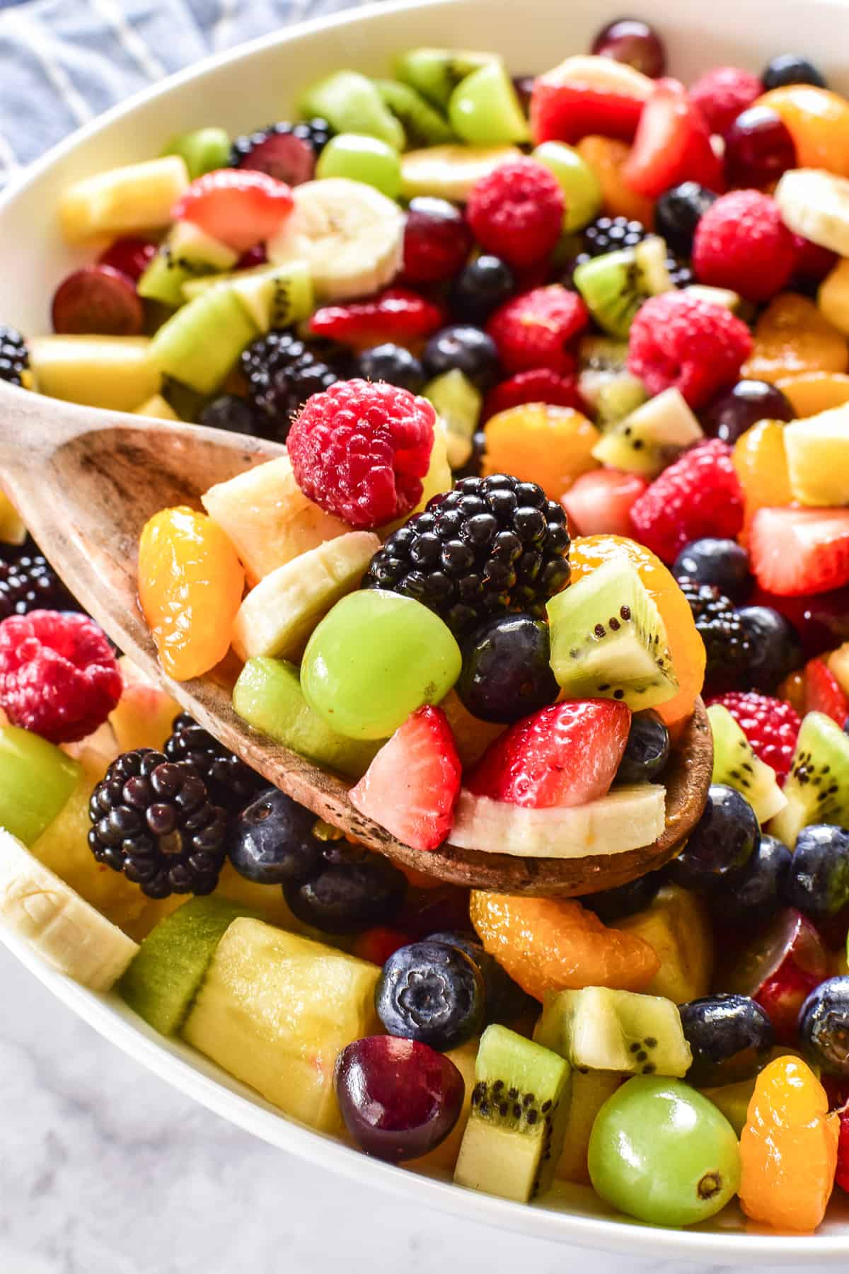 Close up of Fruit Salad on a wooden serving spoon