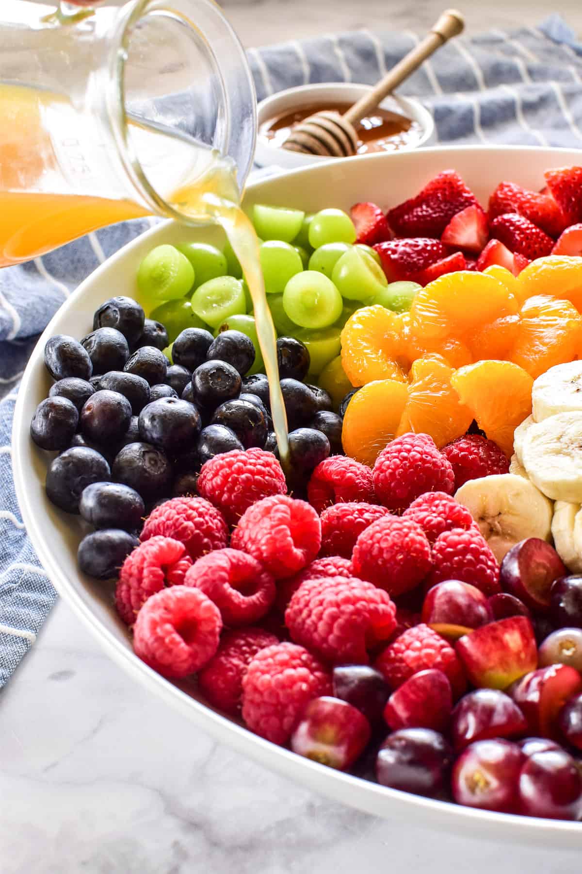 Dressing pouring on fruit salad