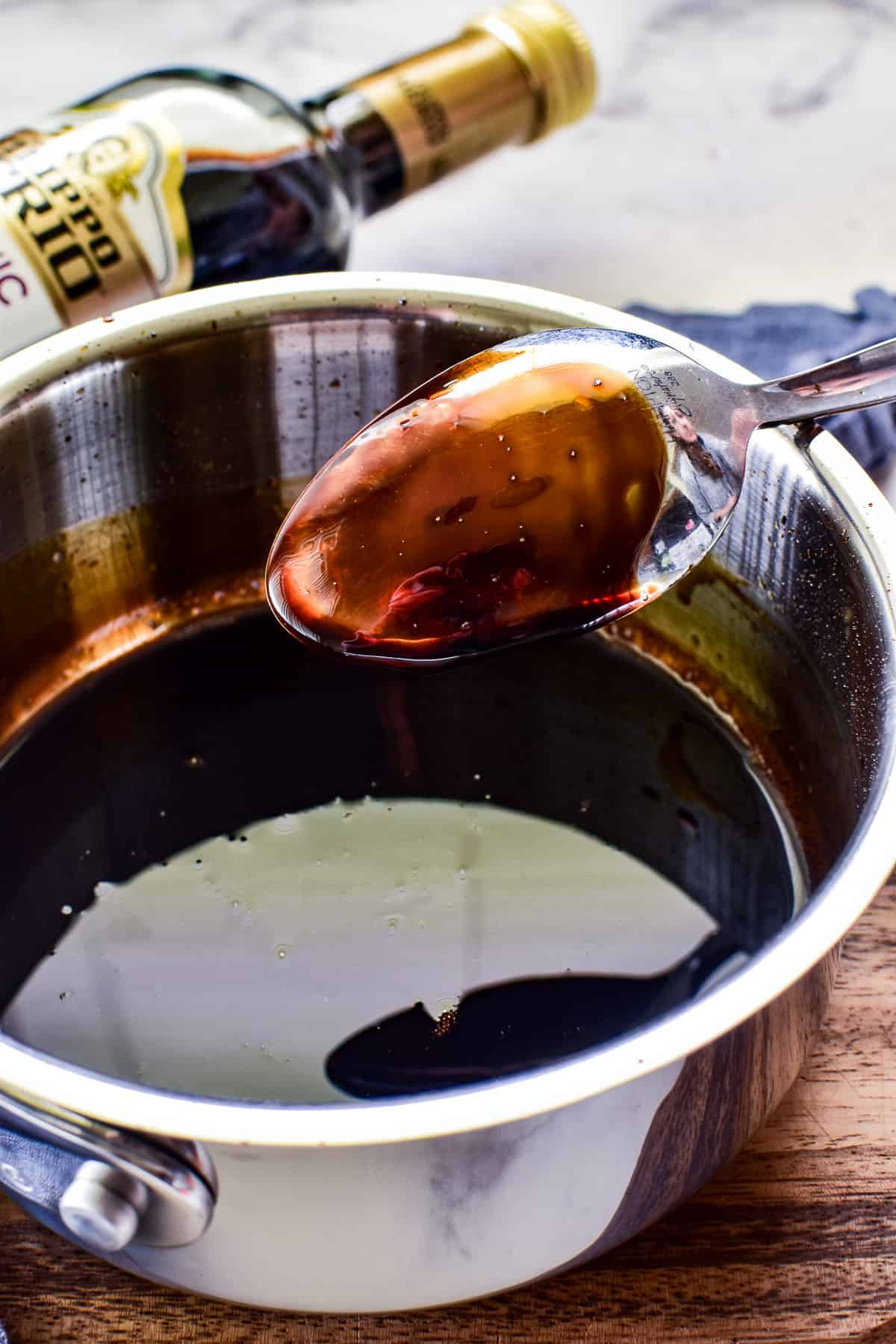 Balsamic glaze coating the back of a spoon