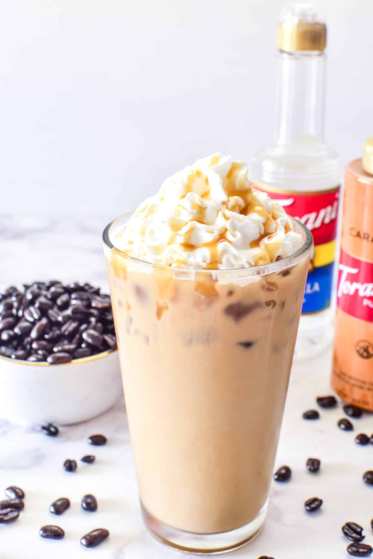 Iced Vanilla Latte with whipped cream and caramel syrup