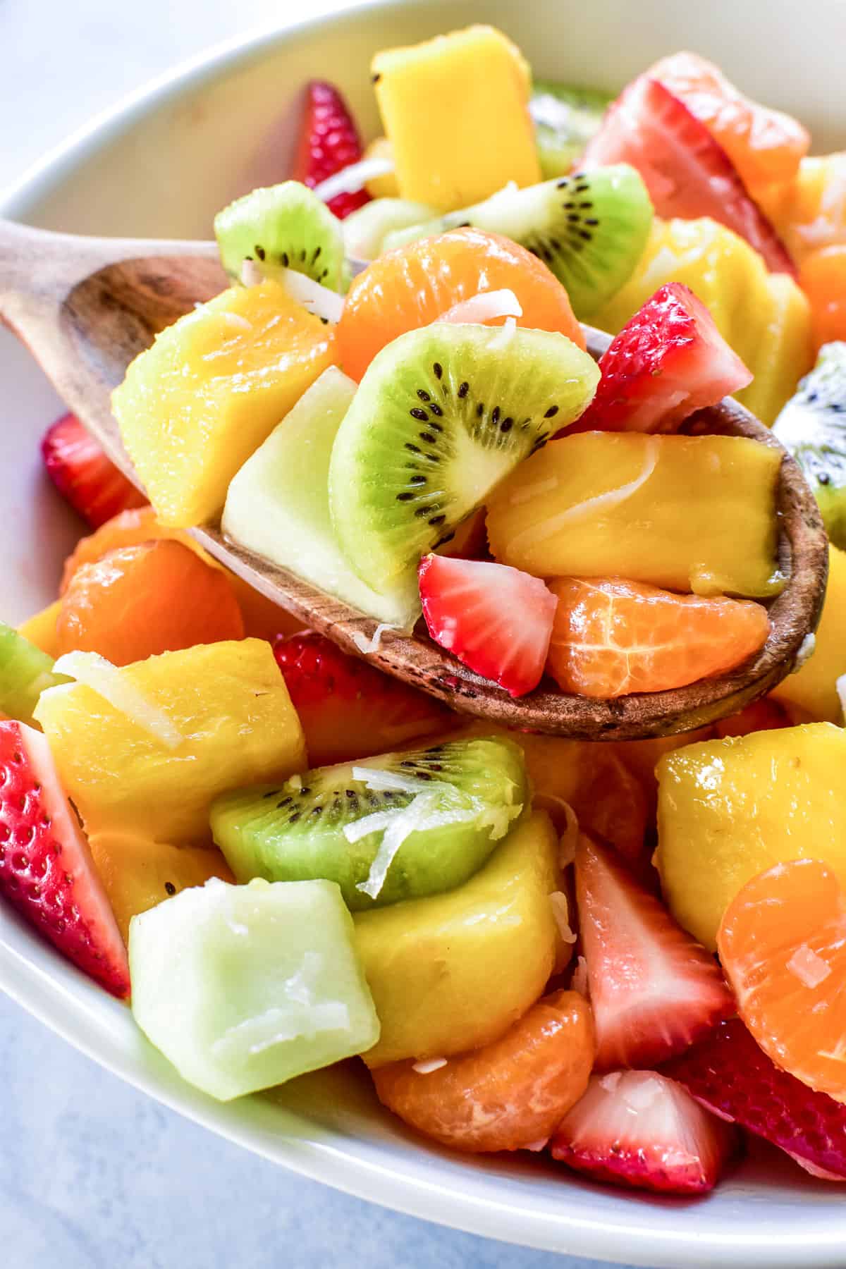 Tropical Fruit Salad served with a wooden spoon