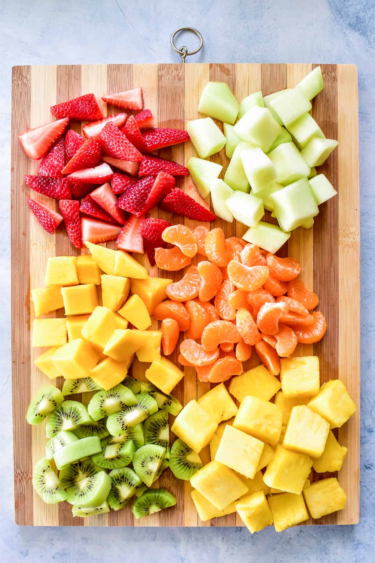 Chopped fruit on a wooden cutting board