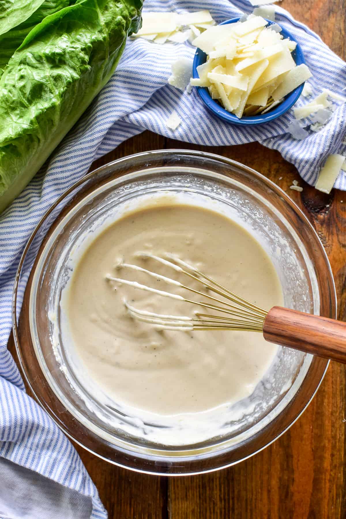 Caesar Dressing in a mixing bowl with a whisk