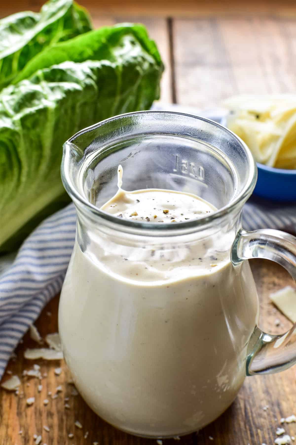 Homemade Caesar Dressing in a small glass pitcher