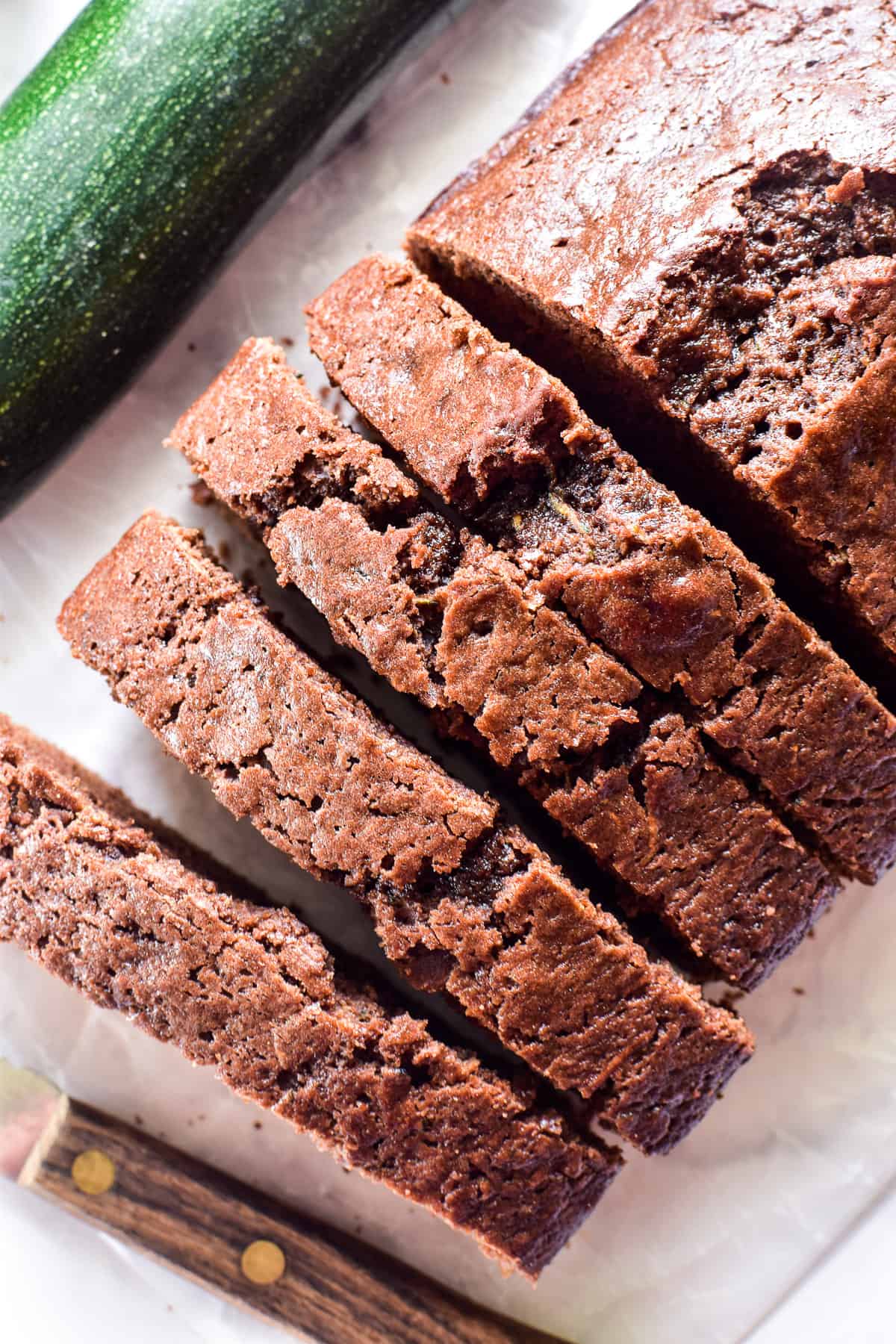 Sliced Chocolate Zucchini Bread with fresh zucchini