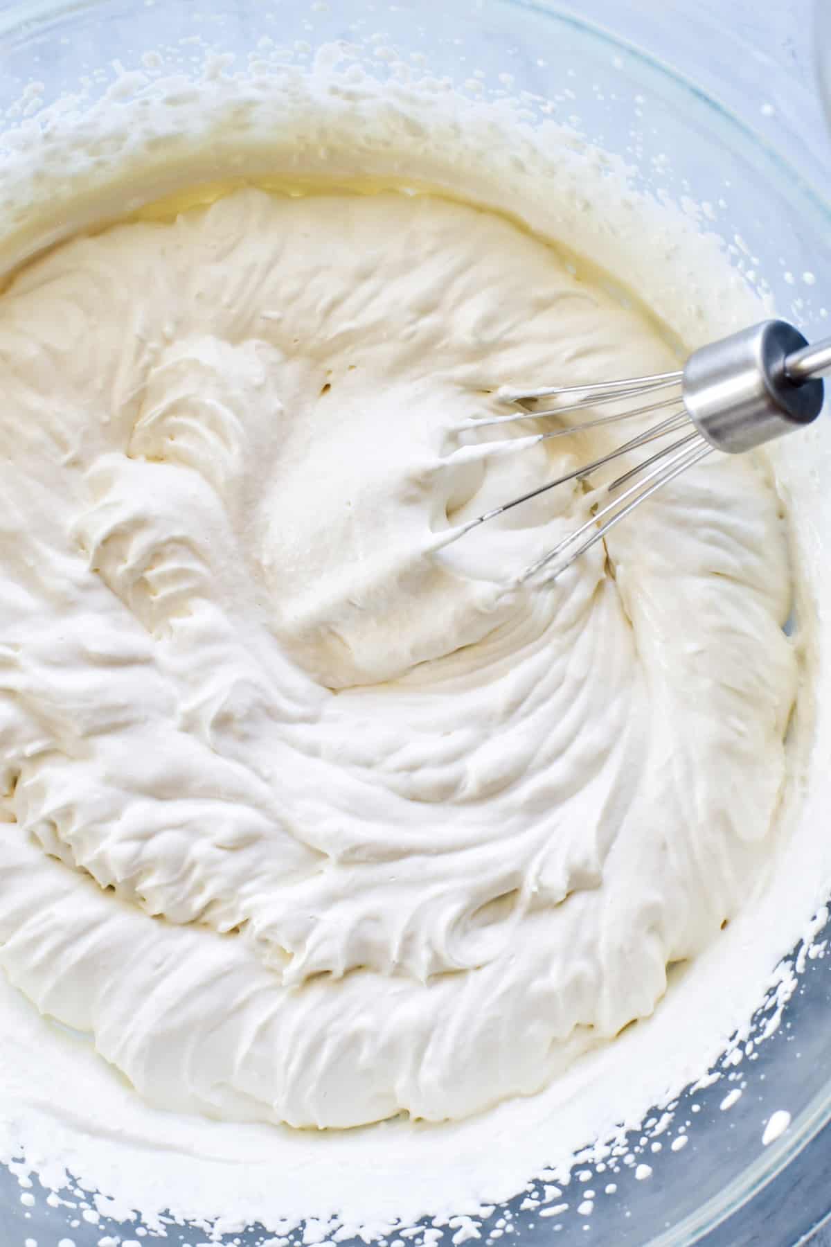 Homemade Cool Whip whipped in a glass mixing bowl