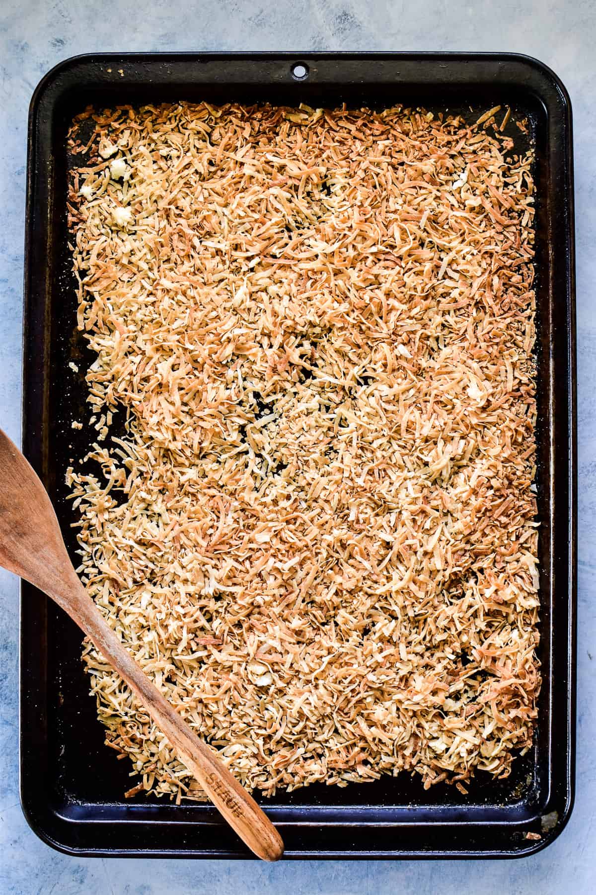 Toasted coconut on a rimmed baking sheet