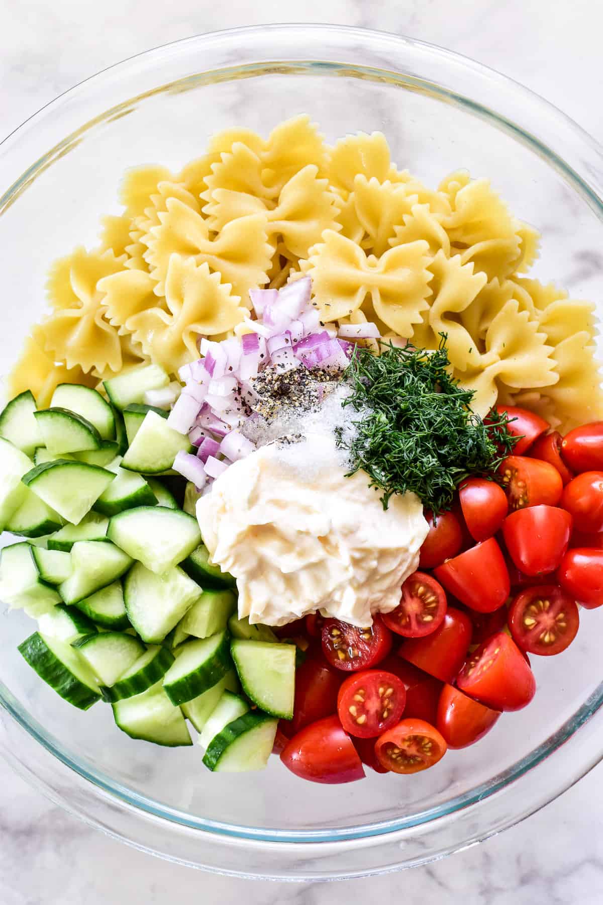 Cucumber Pasta Salad ingredients chopped in a mixing bowl