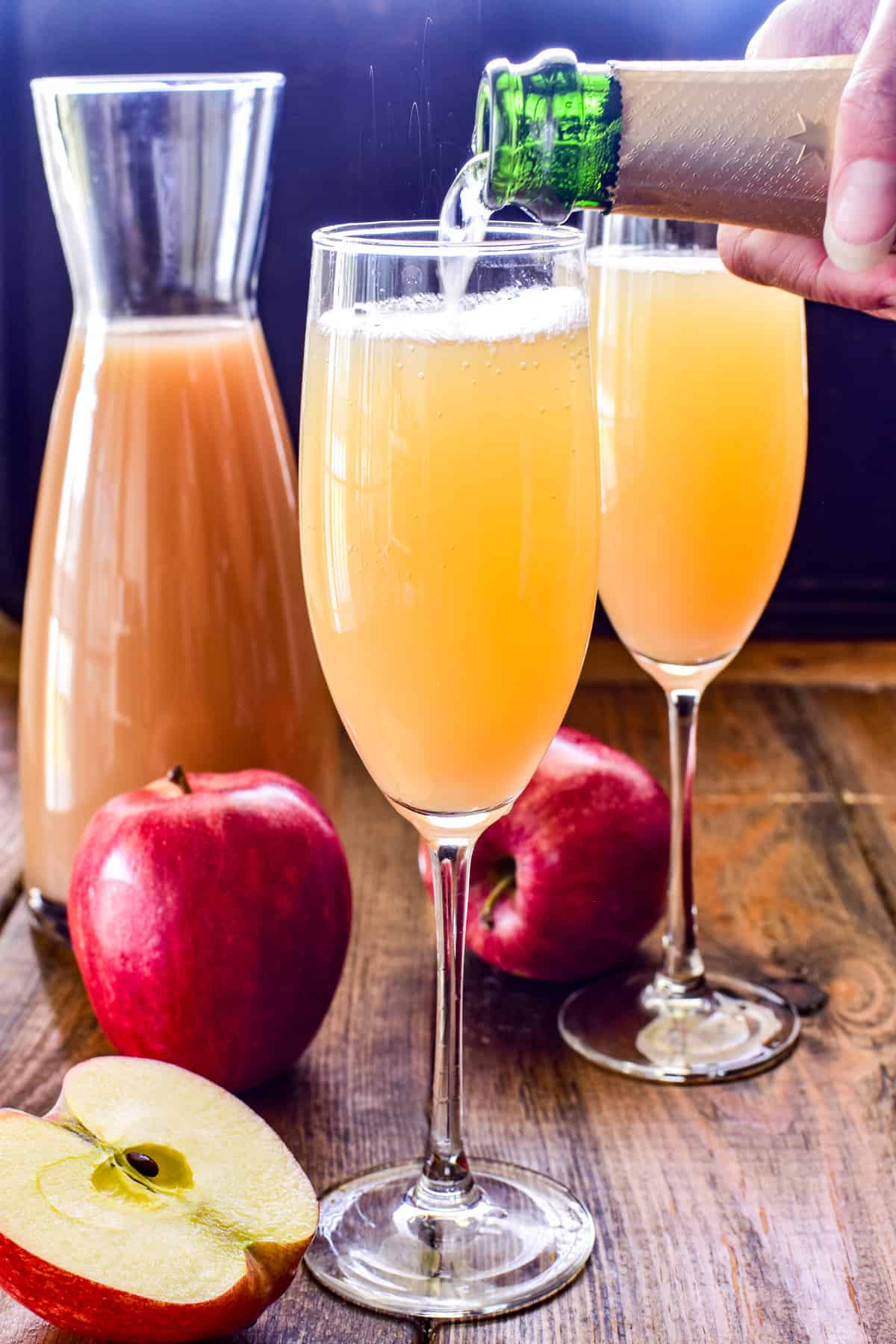 Photo of champagne being poured into an Apple Cider Mimosa