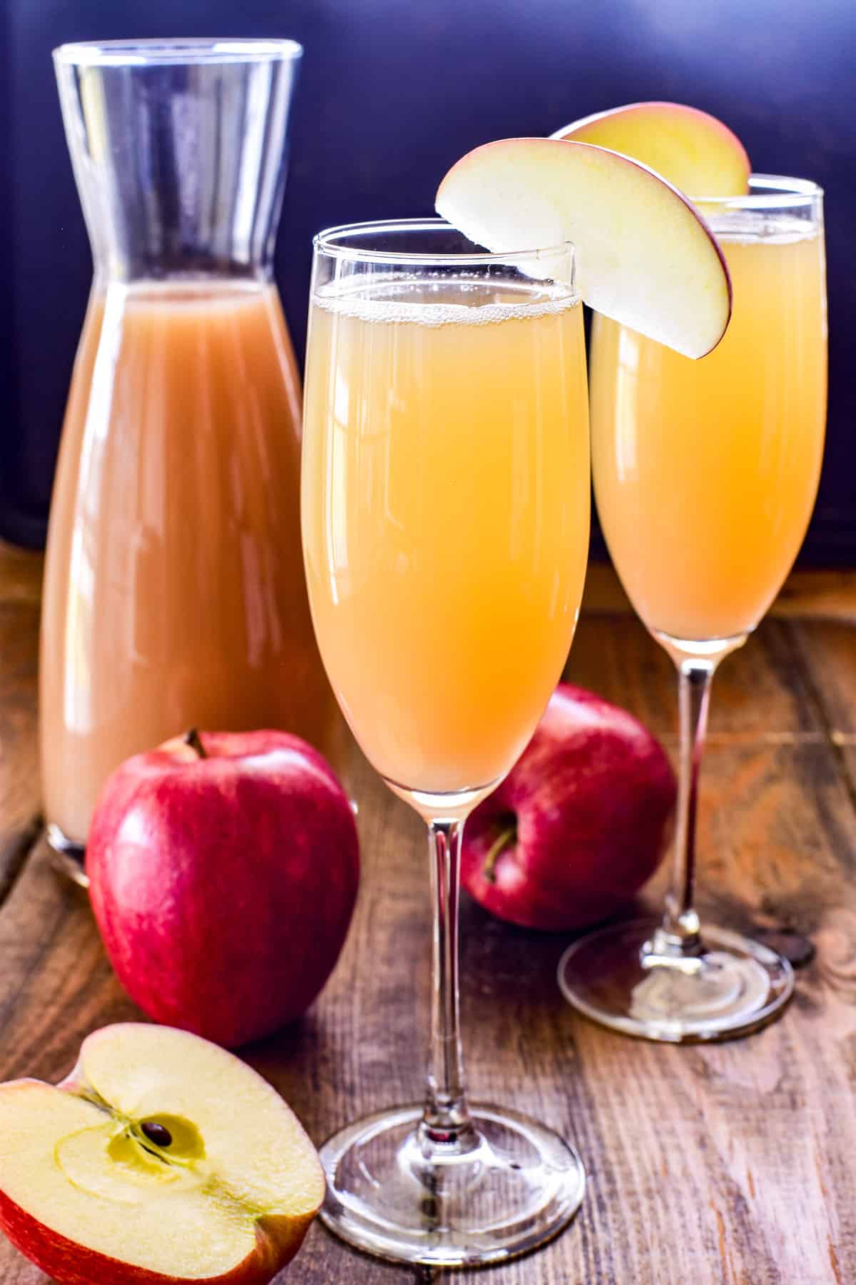 Apple Mimosa in a champagne glass with an apple garnish