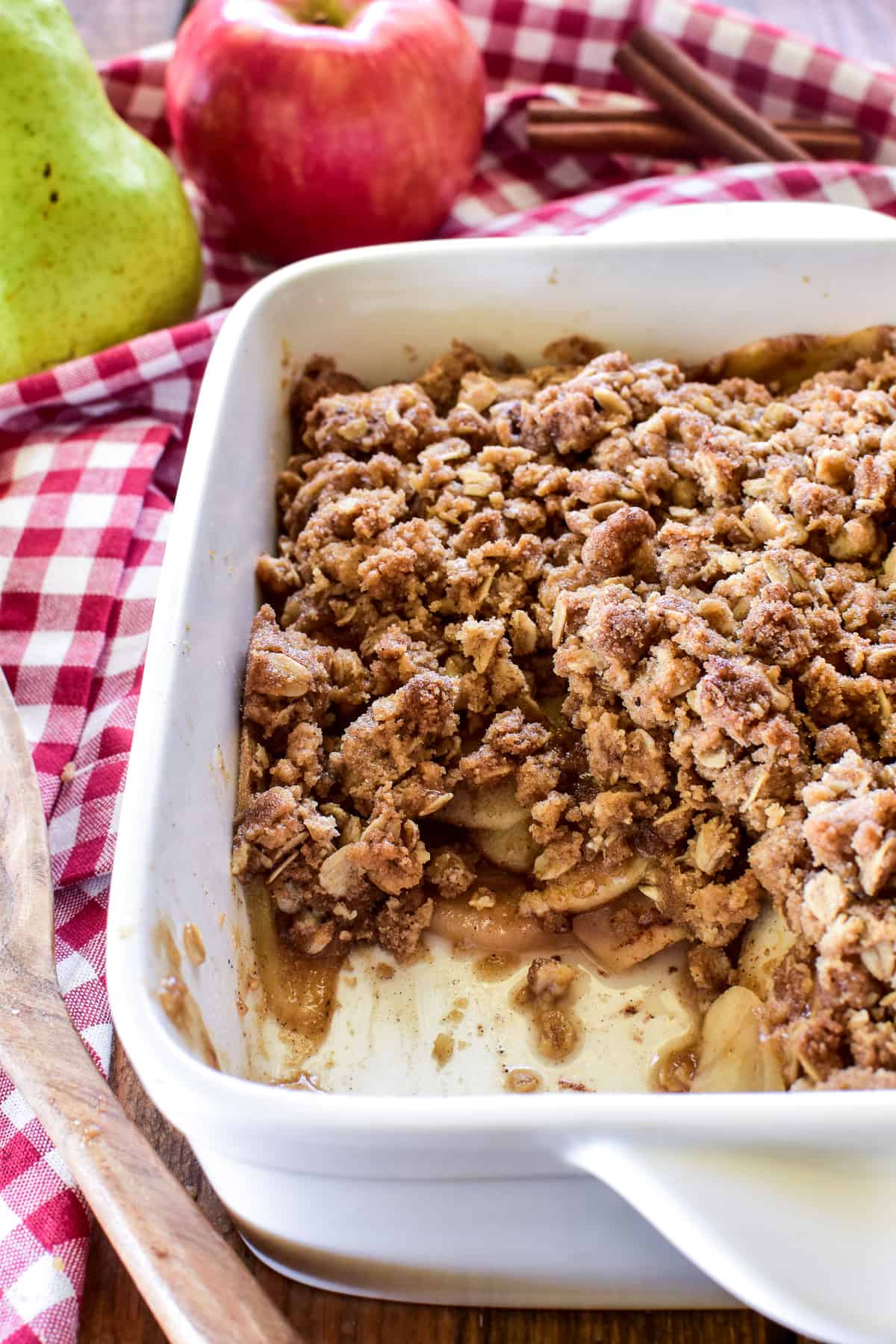 Apple Pear Crisp in an 8x8 inch white pan with a spoonful missing