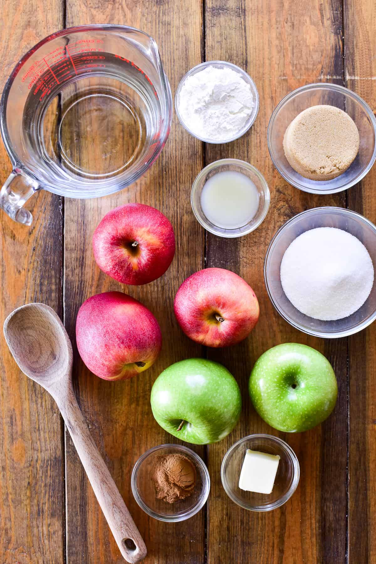Apple pie filling ingredients on a wooden board