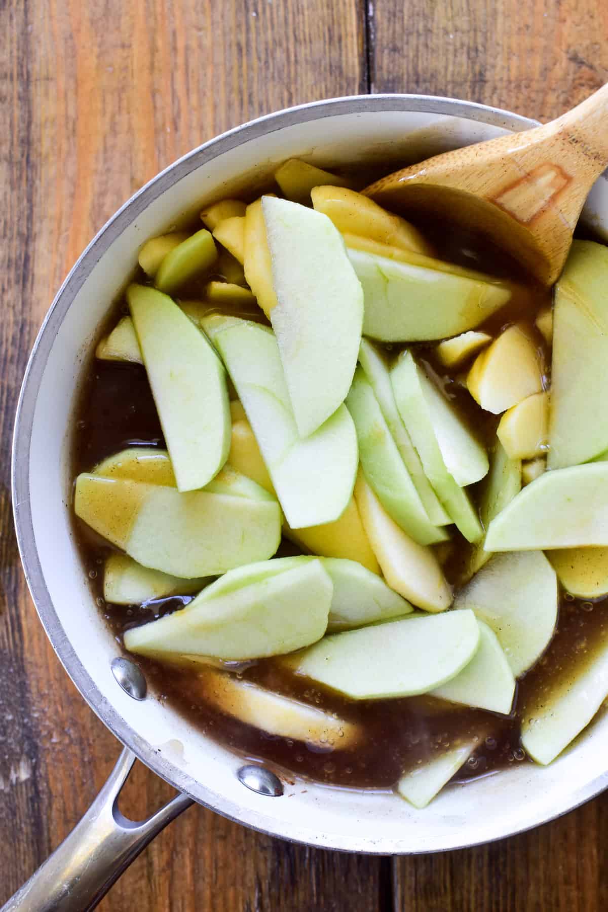 Sliced apples with apple pie filling sauce in a saucepan