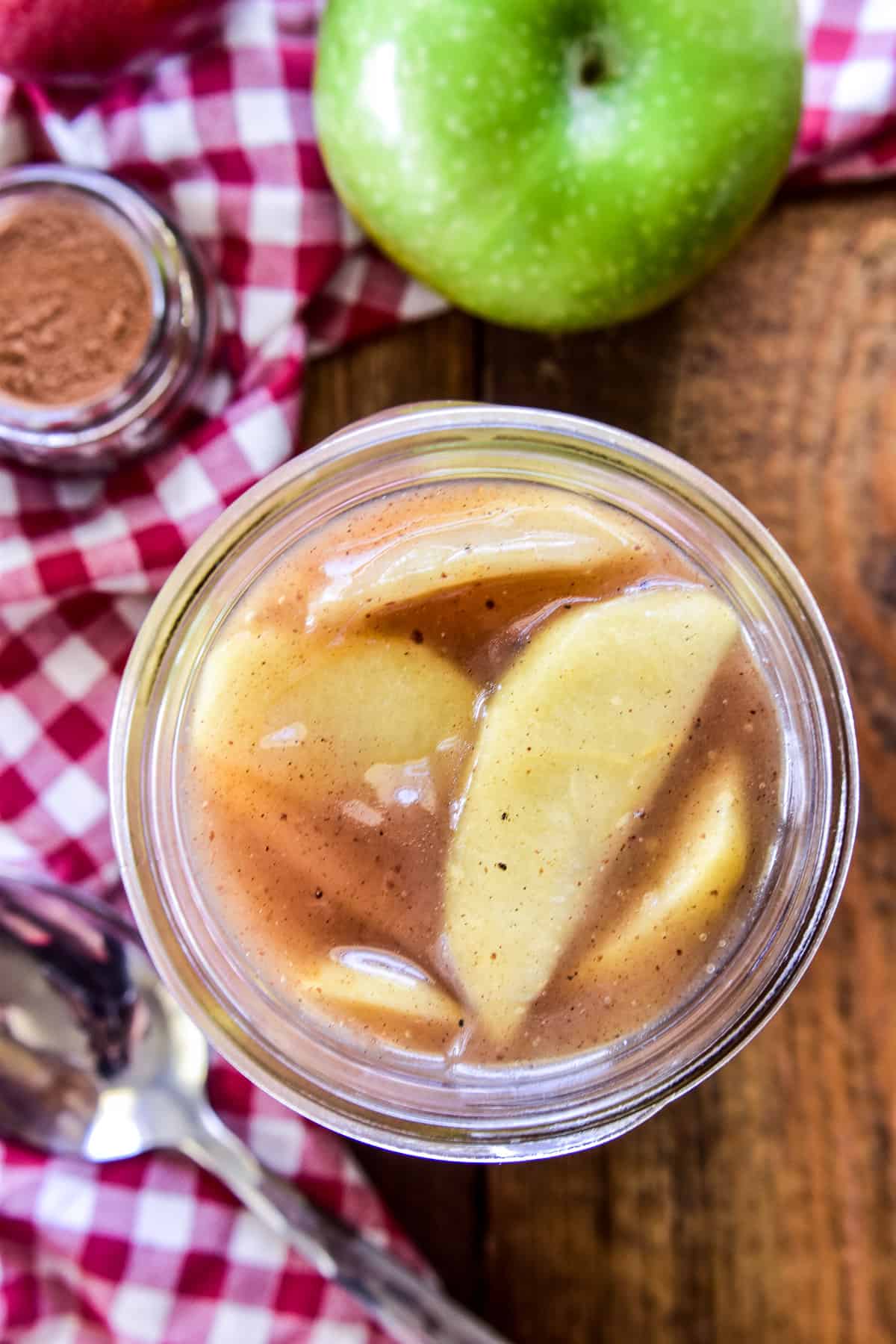 Overhead image of apple pie filling in a glass jar