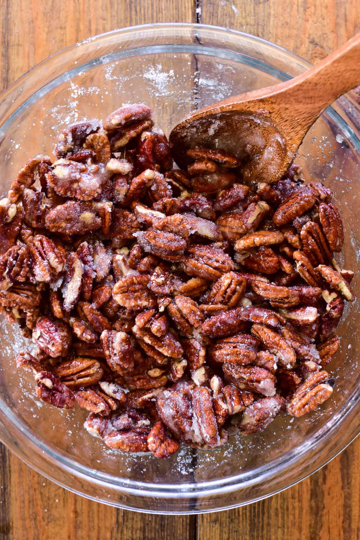 Sugar-coated pecans in a glass mixing bowl