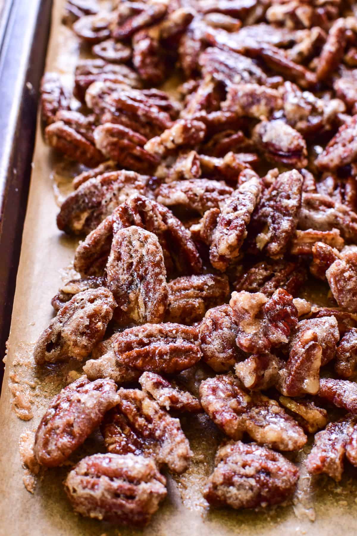 Candied Pecans in a parchment paper lined baking sheet