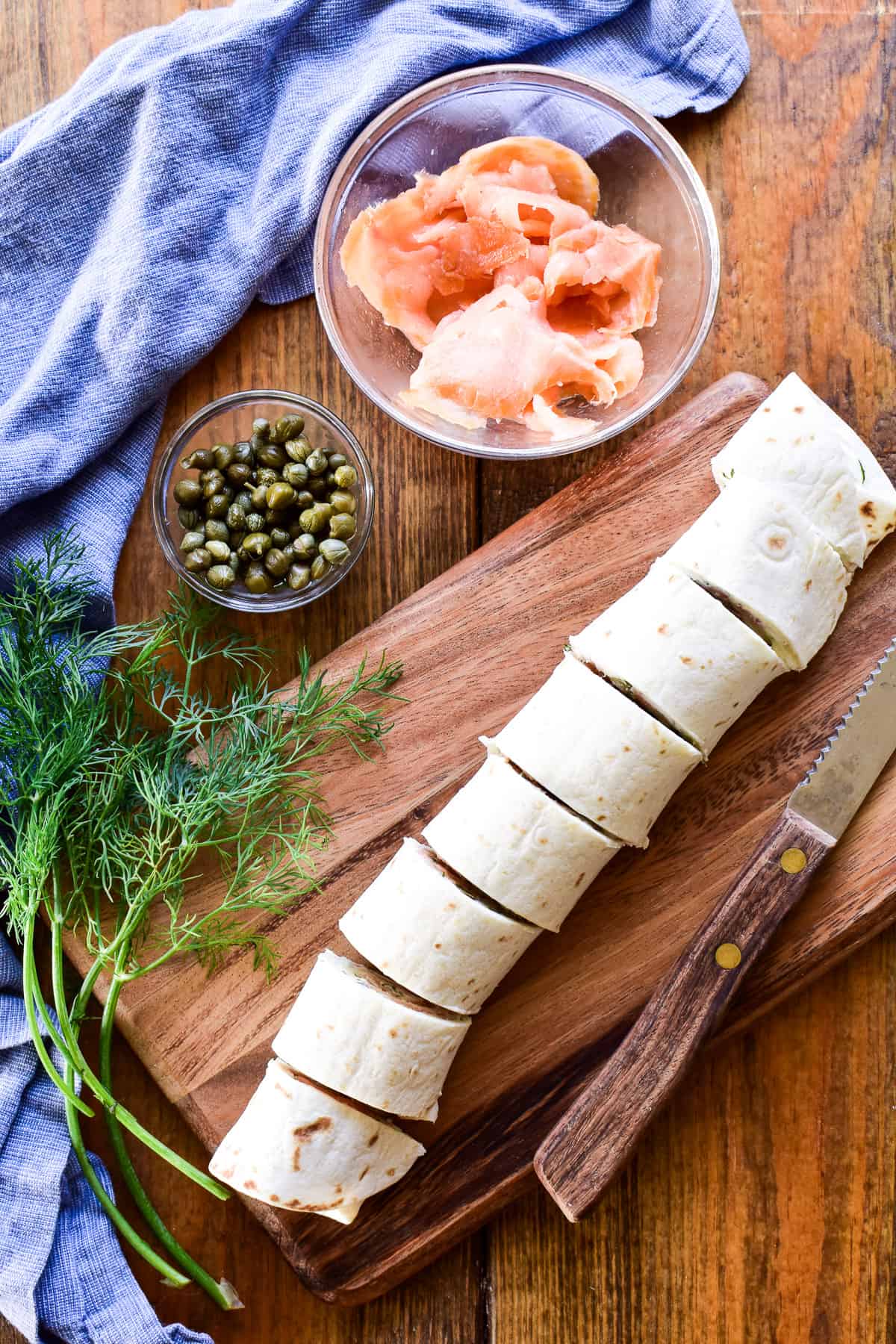 Lox Cream Cheese Pinwheel slices on a wooden cutting board