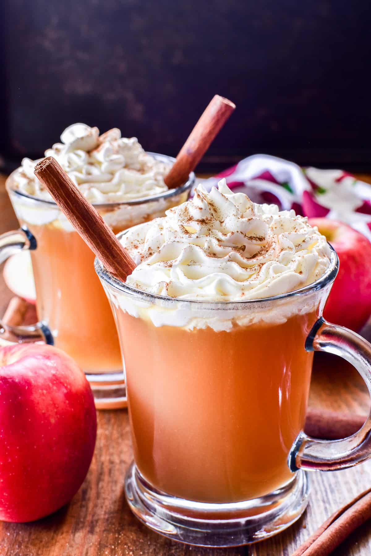 2 glasses of Spiked Apple Cider with whipped cream and cinnamon