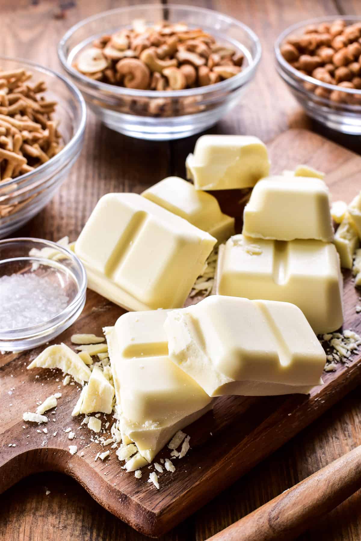 Chopped white chocolate on a wooden cutting board