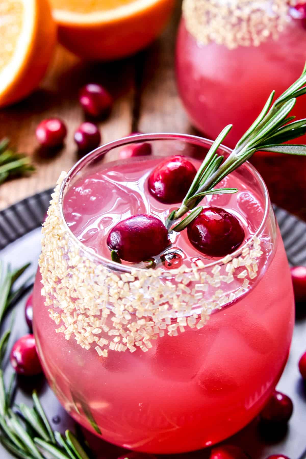 Close up of Cranberry Margarita with fresh cranberries and rosemary
