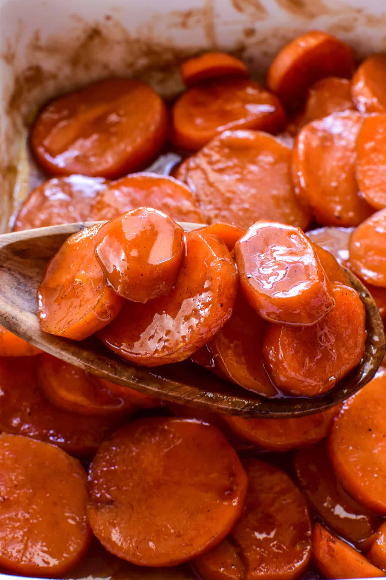 Closeup of Candied Yams on a wooden serving spoon