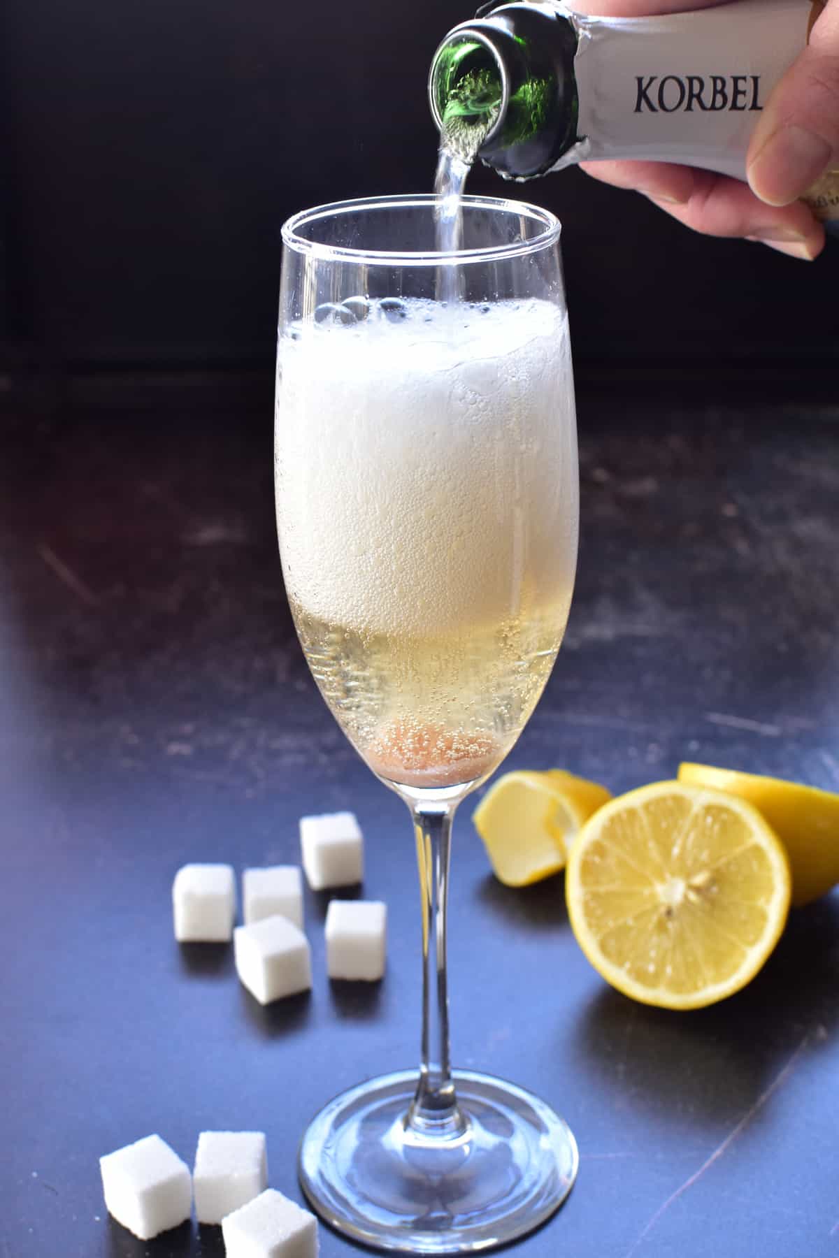 Pouring champagne into a champagne cocktail
