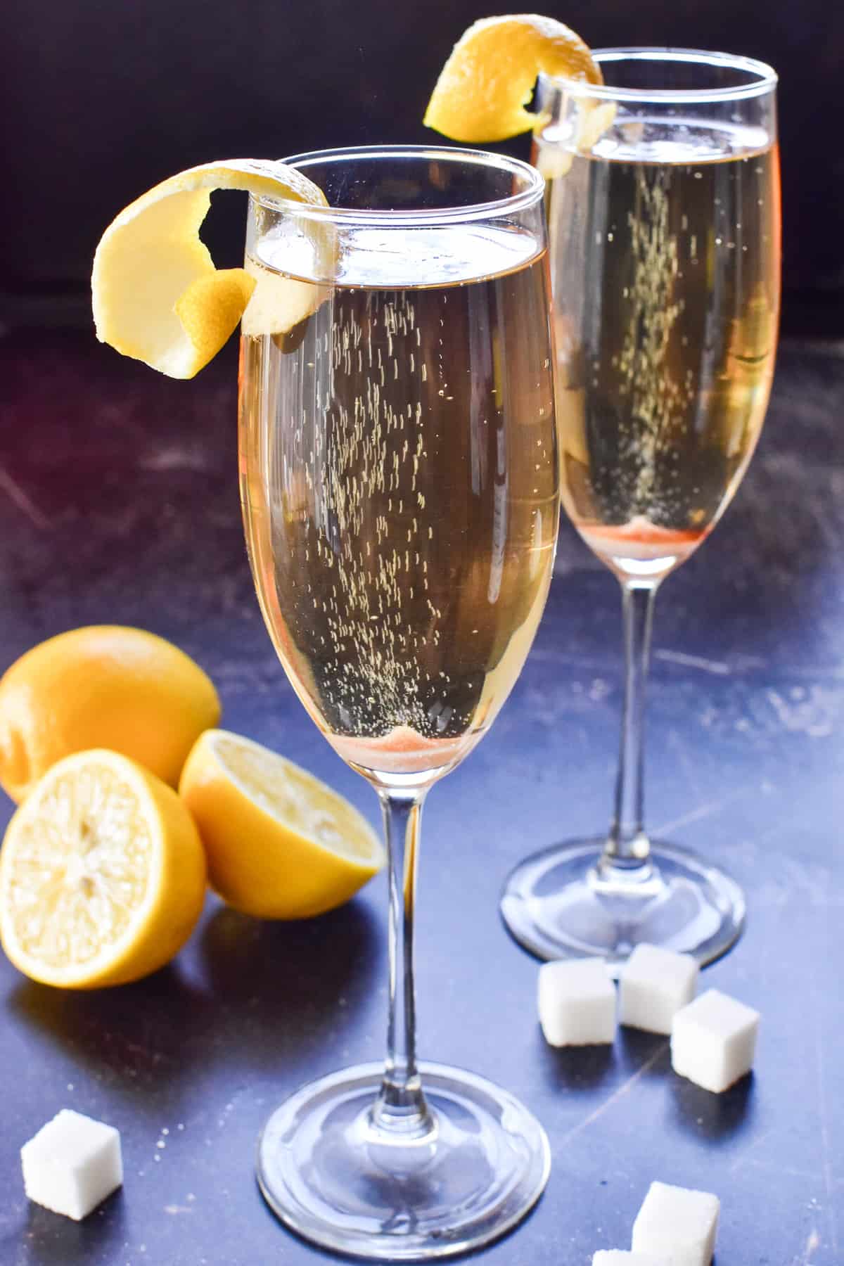 Bubbly Champagne Cocktails with lemons and sugar cubes