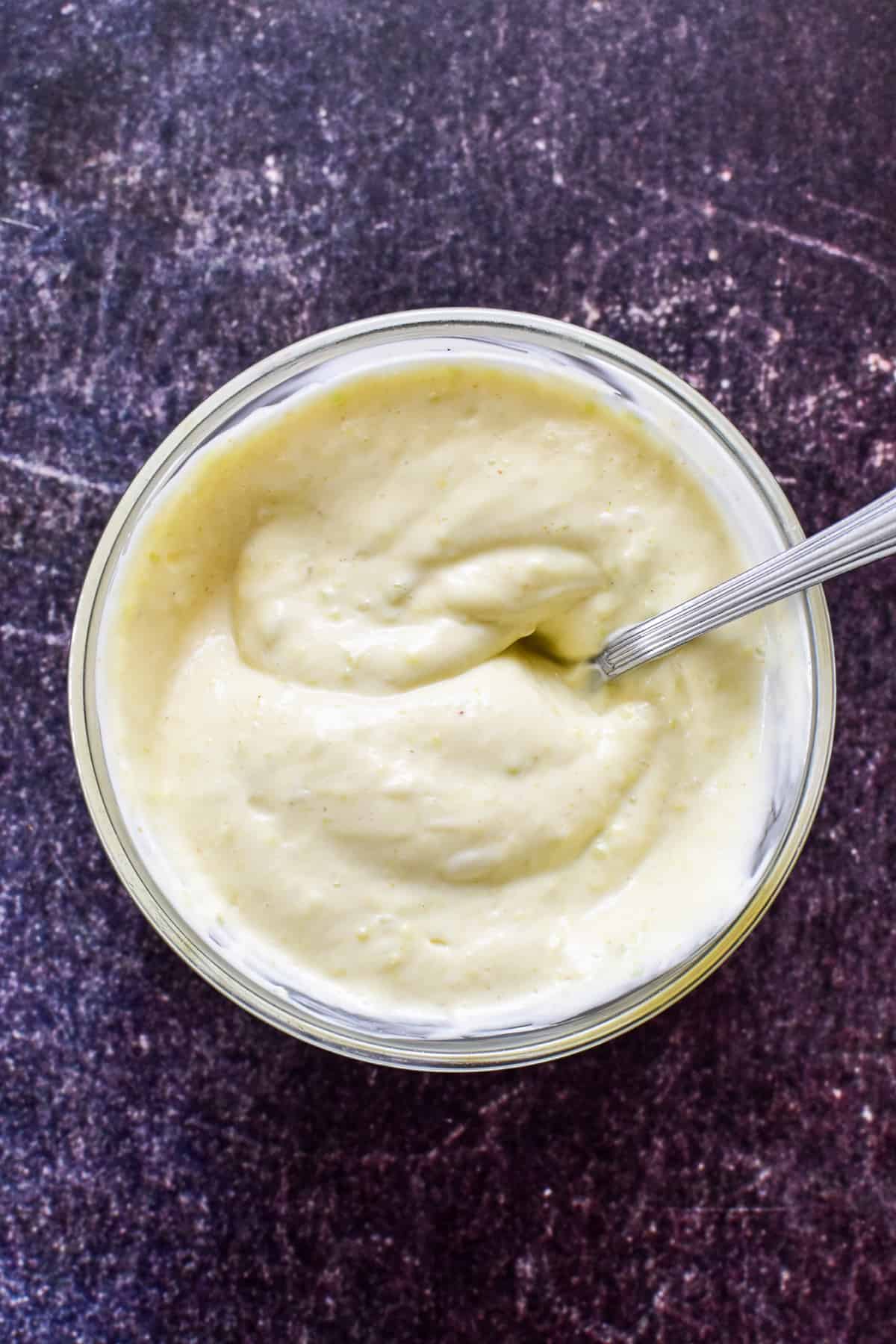 Wasabi Mayo ingredients combined in a glass mixing bowl with a silver spoon